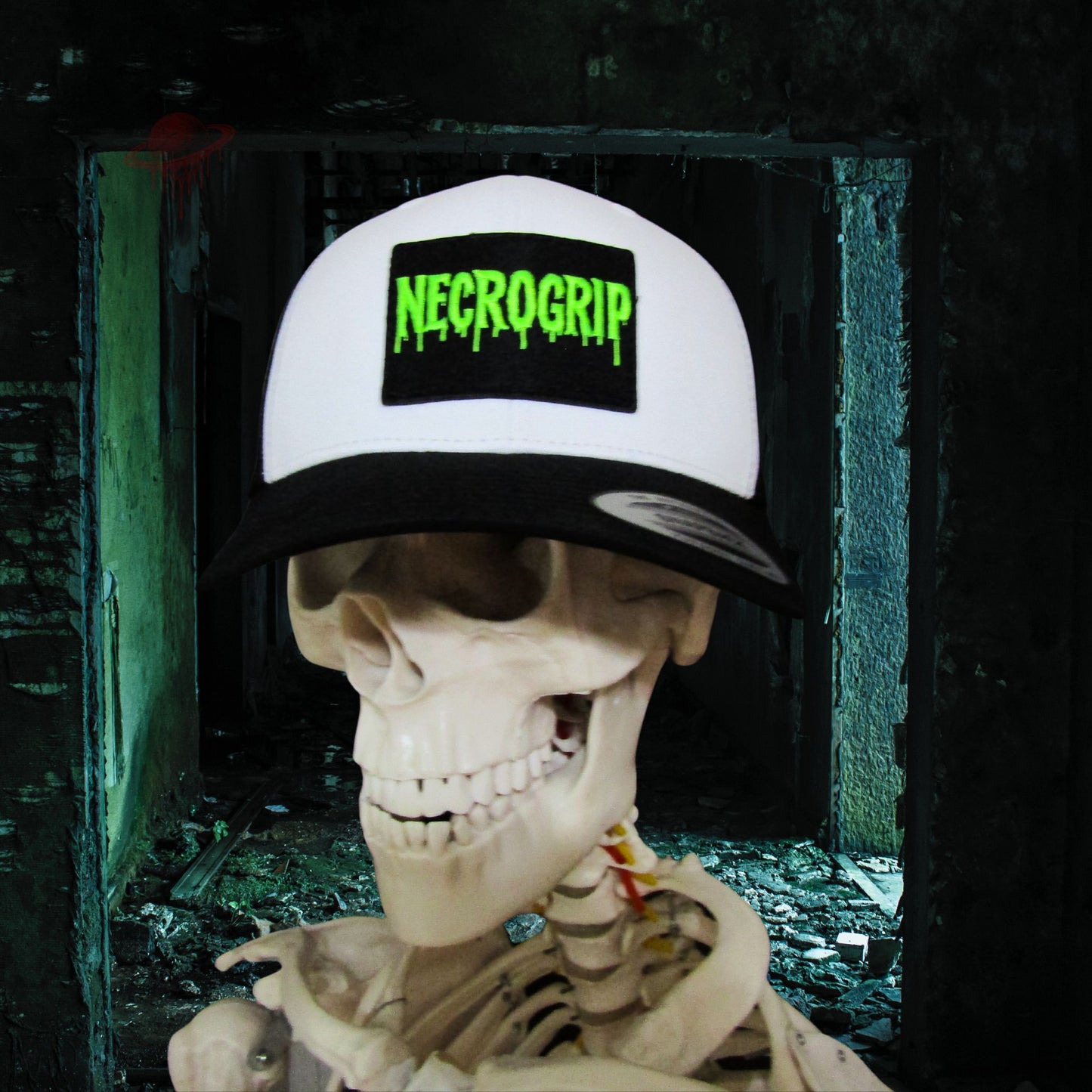 Skeleton model wearing black snapback cap with sewn NECROGRIP logo patch, eerie background.