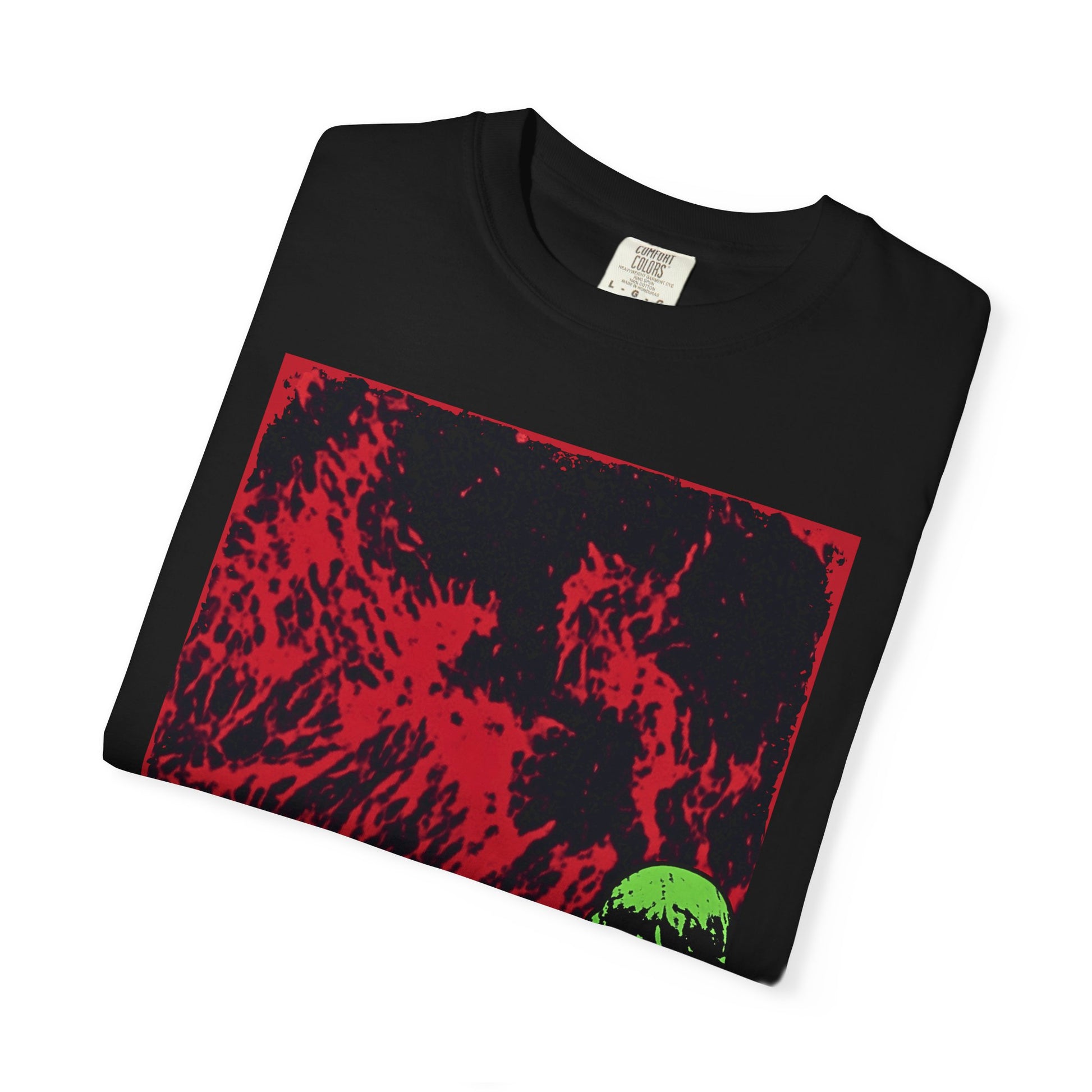 Folded close up of a black gothic t-shirt featuring a green graveyard statue in the corner of a red and black moon-like scene.