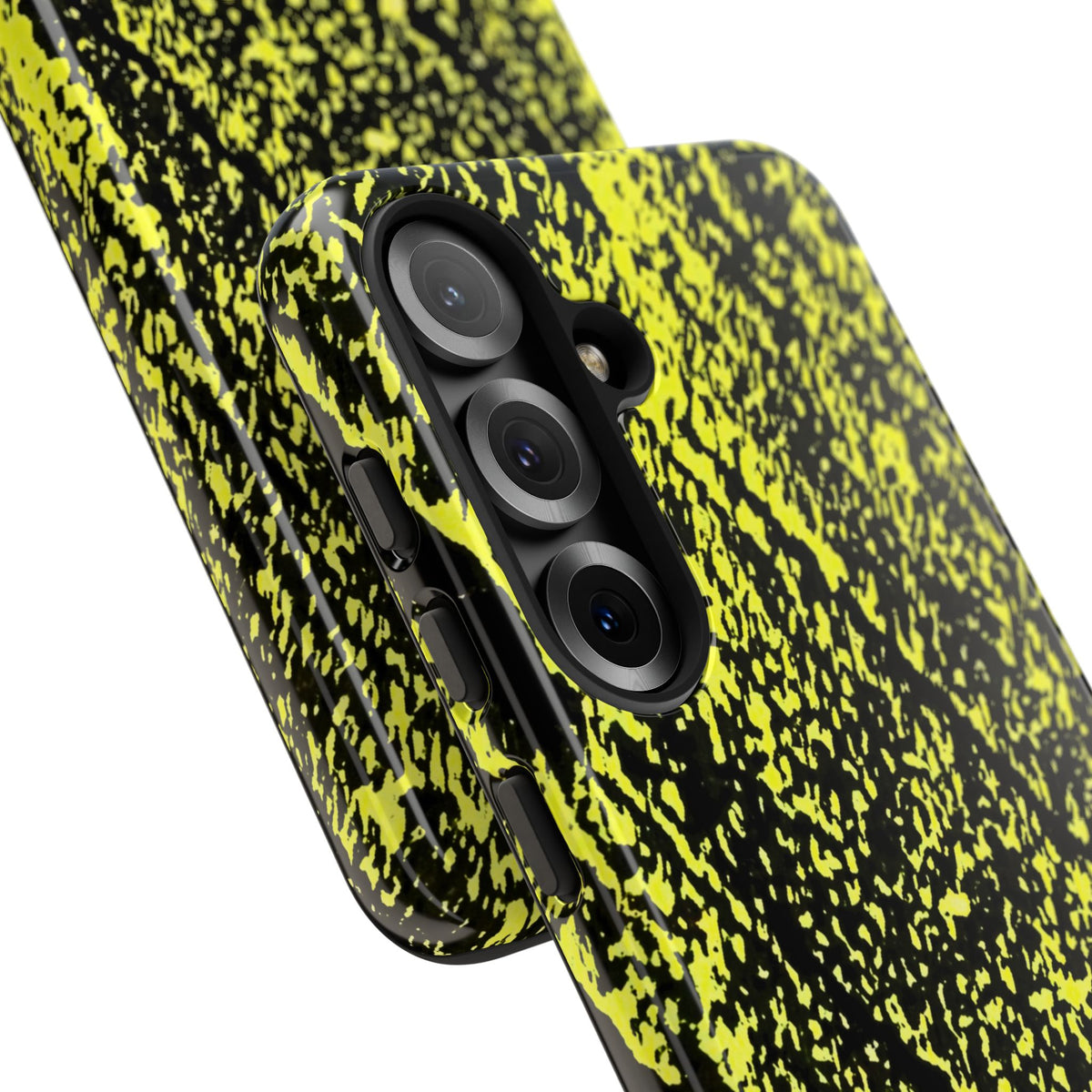 A close-up of a smartphone case with a black and neon yellow splatter pattern, shown fitted on a phone against a plain white background.