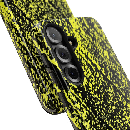 A close-up of a smartphone case with a black and neon yellow splatter pattern, shown fitted on a phone against a plain white background.