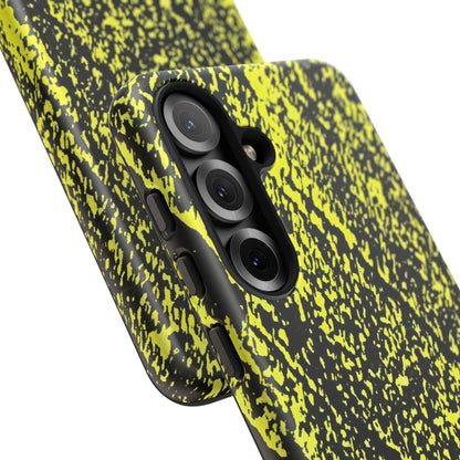 Close-up of a smartphone case with a black and neon yellow splatter pattern, showing the camera cutout and side buttons against a white background.