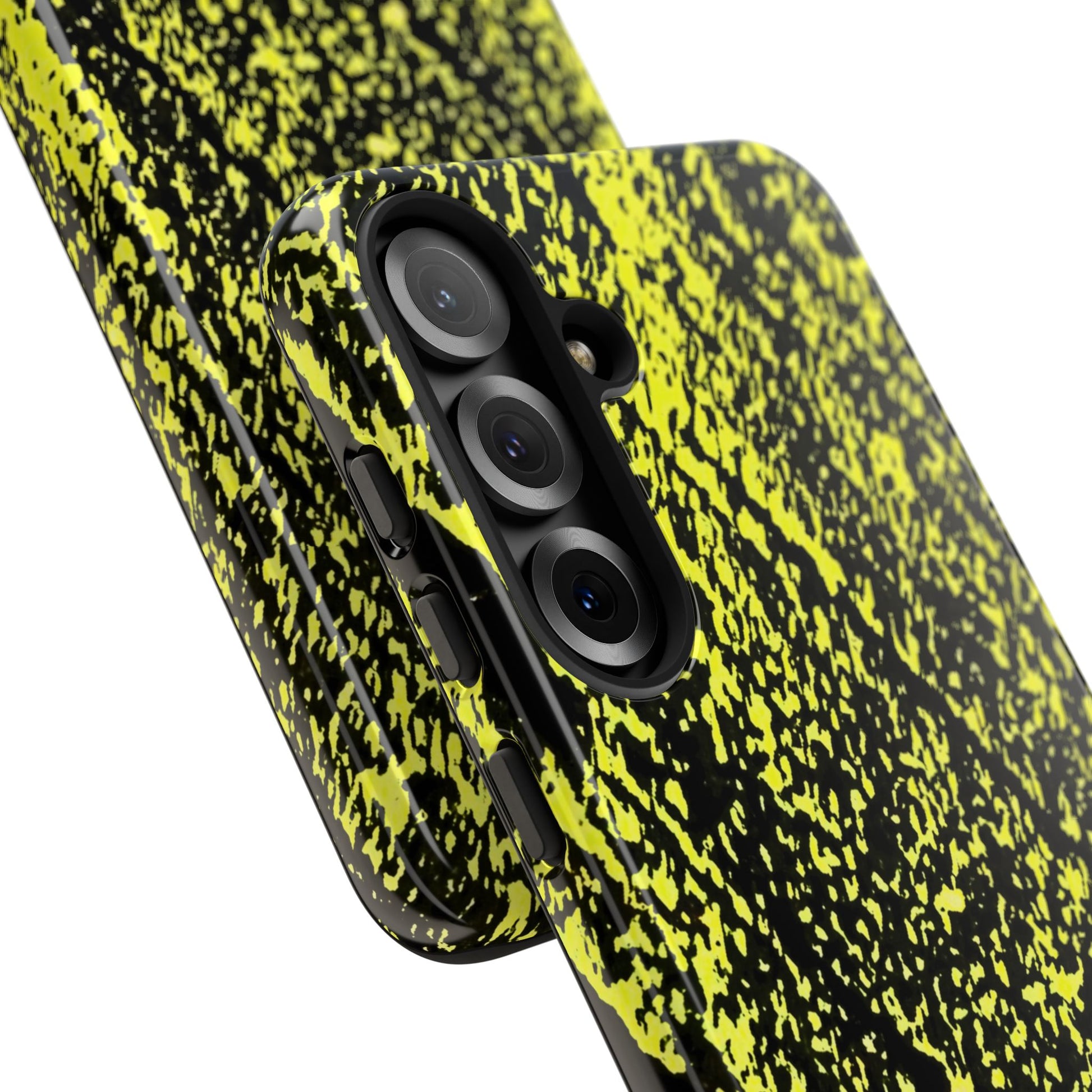 A close-up of a smartphone case with a high-contrast black and neon yellow-green splatter pattern, shown on a phone against a white background.