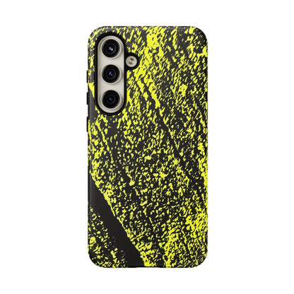 A protective phone case featuring a high-contrast abstract pattern of bright neon yellow paint splatters and streaks over a solid black background, shown on a clean white studio backdrop.