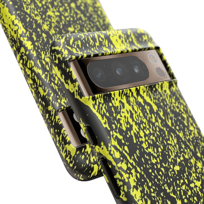 Close-up of a smartphone case with a black and neon yellow splatter pattern, fitted on a phone, shown against a plain white background.