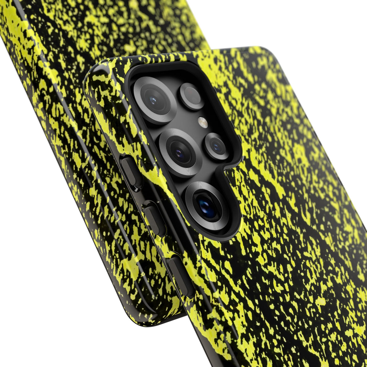 Close-up of a smartphone case with a black and neon yellow splatter pattern, fitted on a phone with a triple-camera system, shown against a plain white background.
