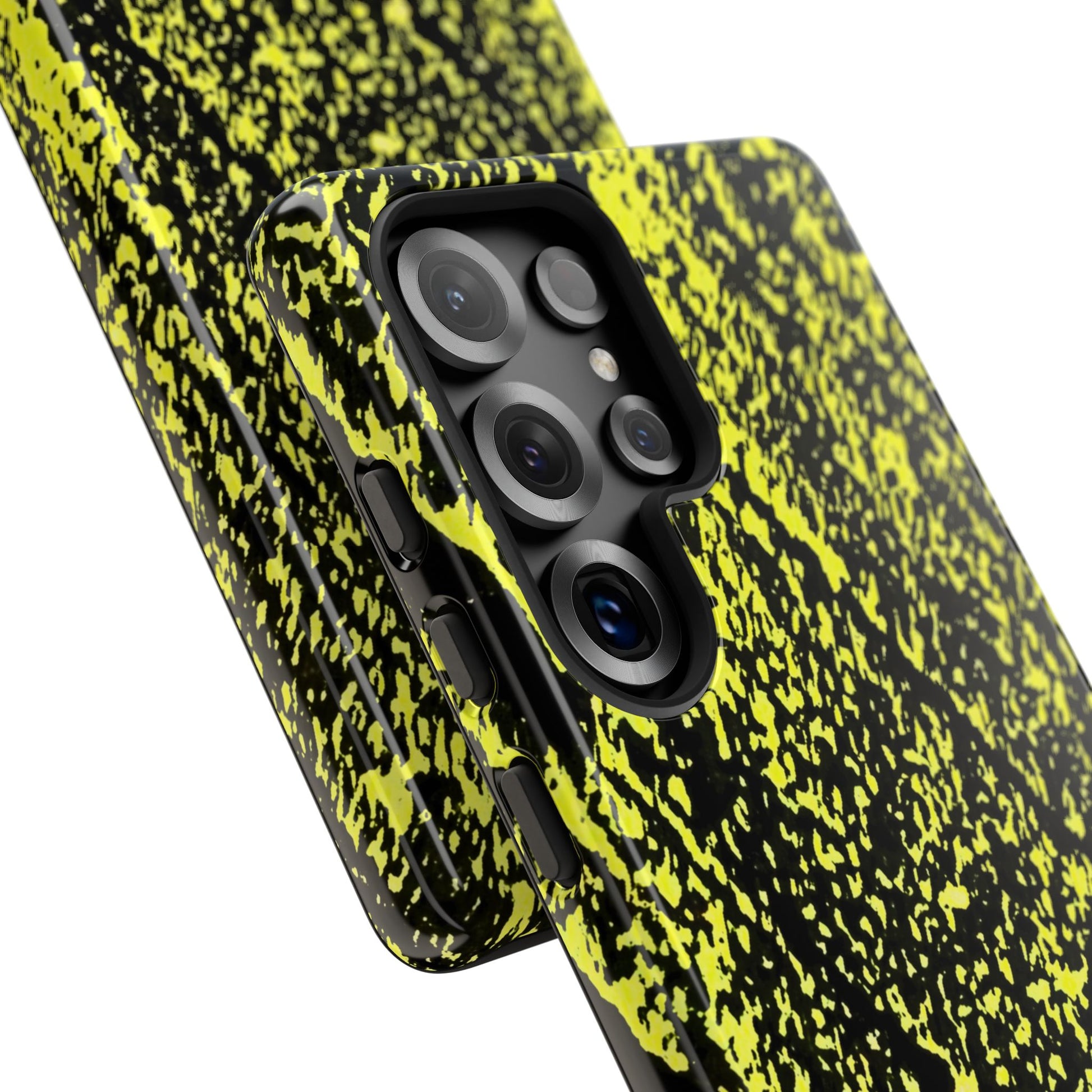 Close-up of a smartphone case with a black and neon yellow splatter pattern, fitted on a phone with a triple-camera system, shown against a plain white background.