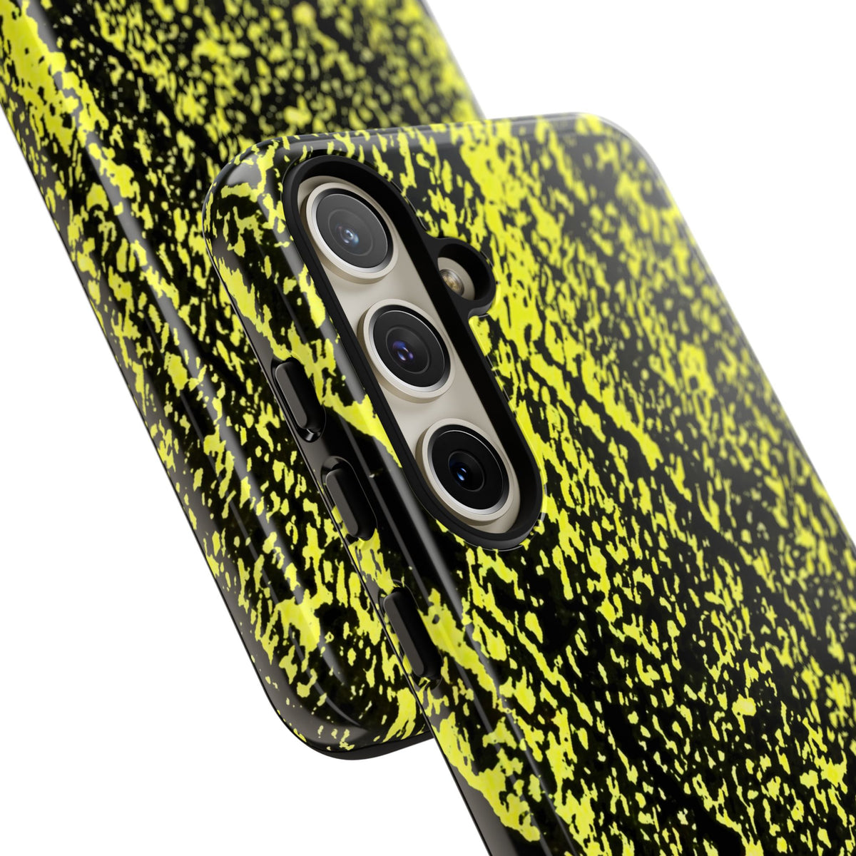 A close-up of a smartphone case with a black and neon yellow splatter pattern, fitted on a phone, shown against a plain white background.