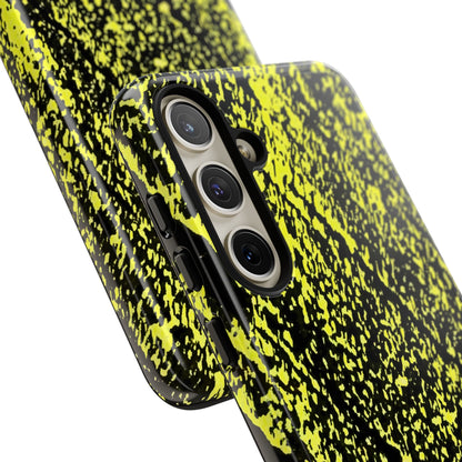 A close-up of a smartphone case with a black and neon yellow splatter pattern, fitted on a phone, shown against a plain white background.