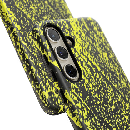 A close-up of a smartphone case with a black and neon yellow splatter pattern, fitted on a phone with a triple-camera system, shown against a plain white background.