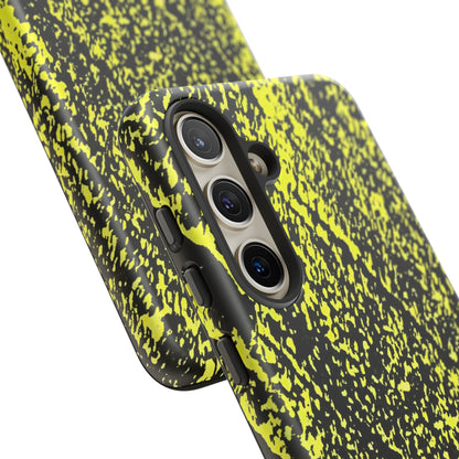 Close-up of a smartphone case with a black and neon yellow splatter pattern, shown on a phone against a white background.