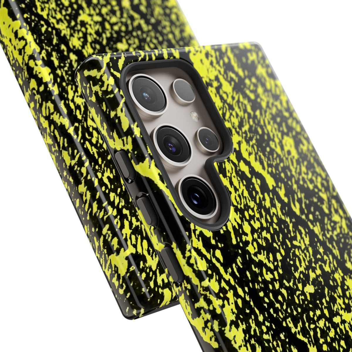 A close-up of a smartphone case with a black and neon yellow splatter pattern, shown fitted on a phone against a clean white background.