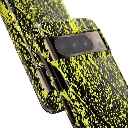 Close-up of a smartphone case with a high-contrast black and neon yellow splatter pattern, fitted on a phone, shown against a plain white background.