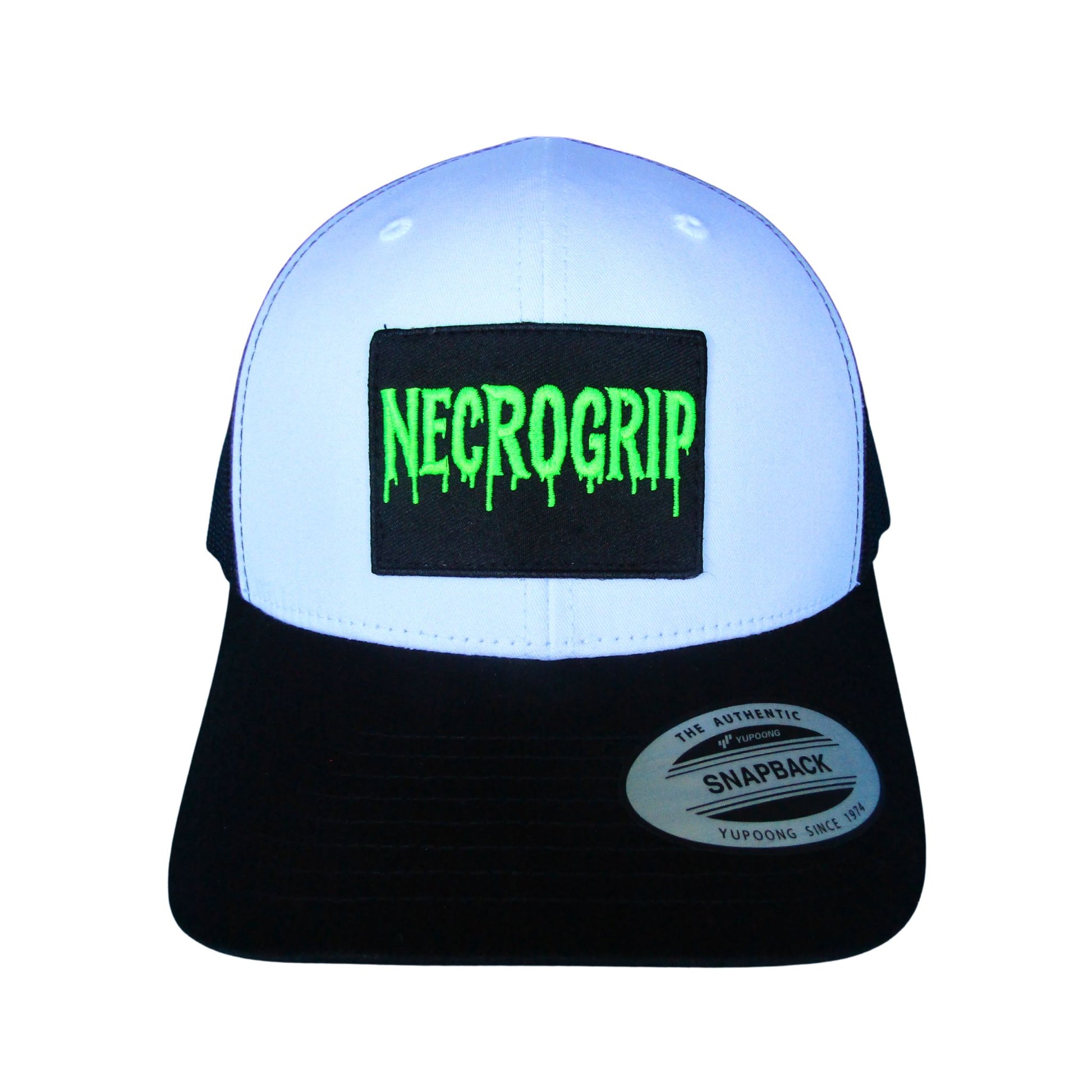 Black snapback cap with sewn NECROGRIP logo patch in neon green lettering, structured crown and mesh back.