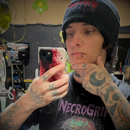 Danny Darknessx holding a NecroGrip tough phone case in a mirror photo.